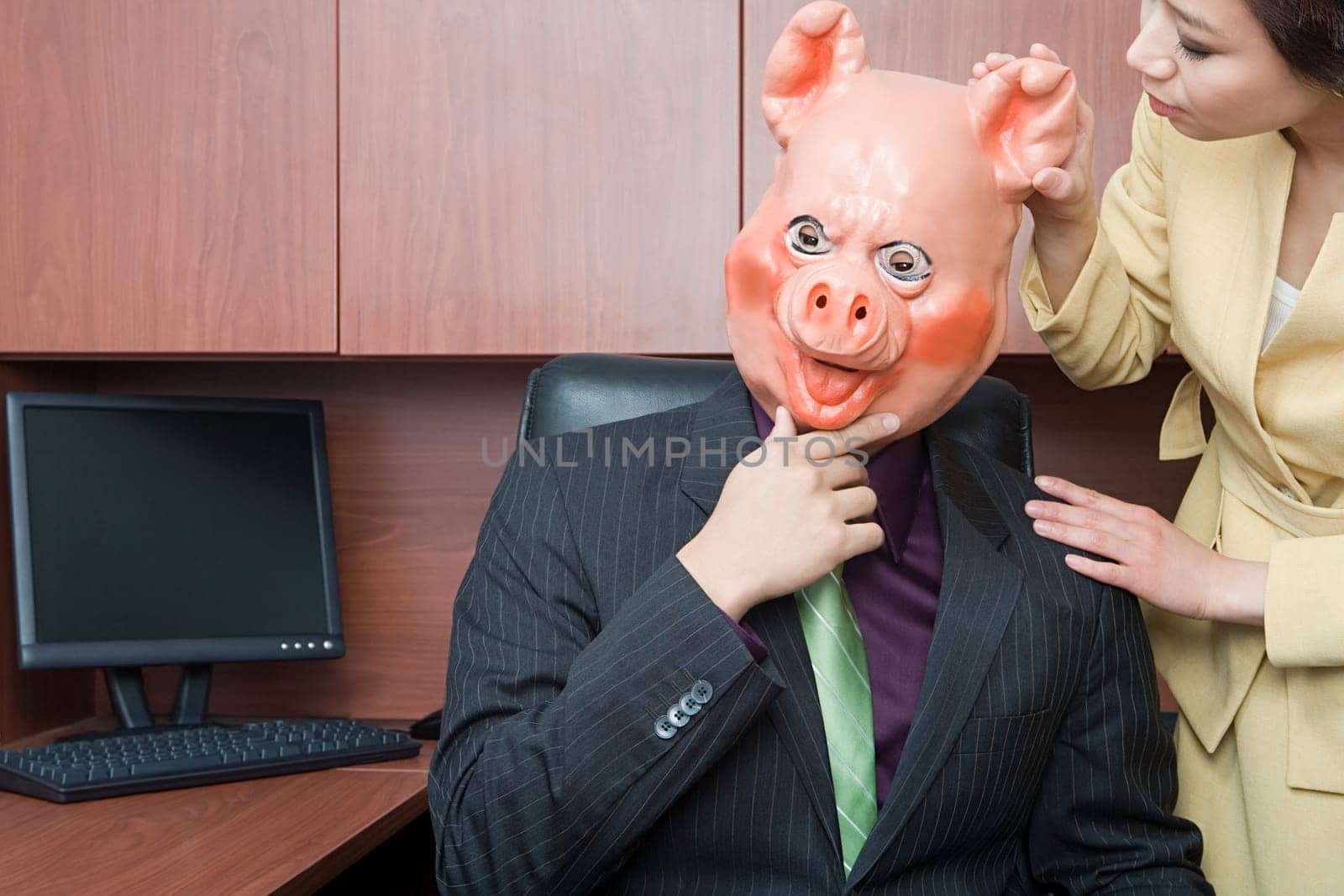 Businessman in pig mask and businesswoman