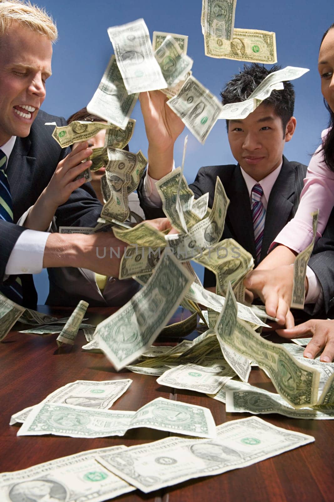 Businesspeople throwing money