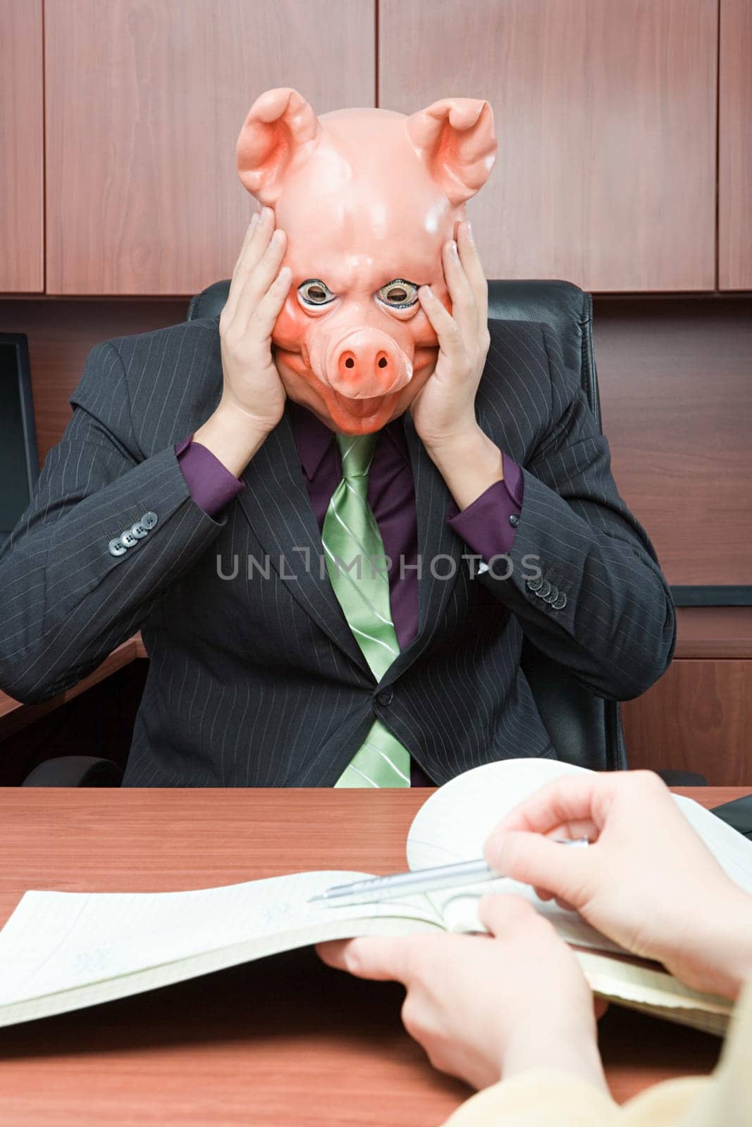 Stressed businessman in pig mask