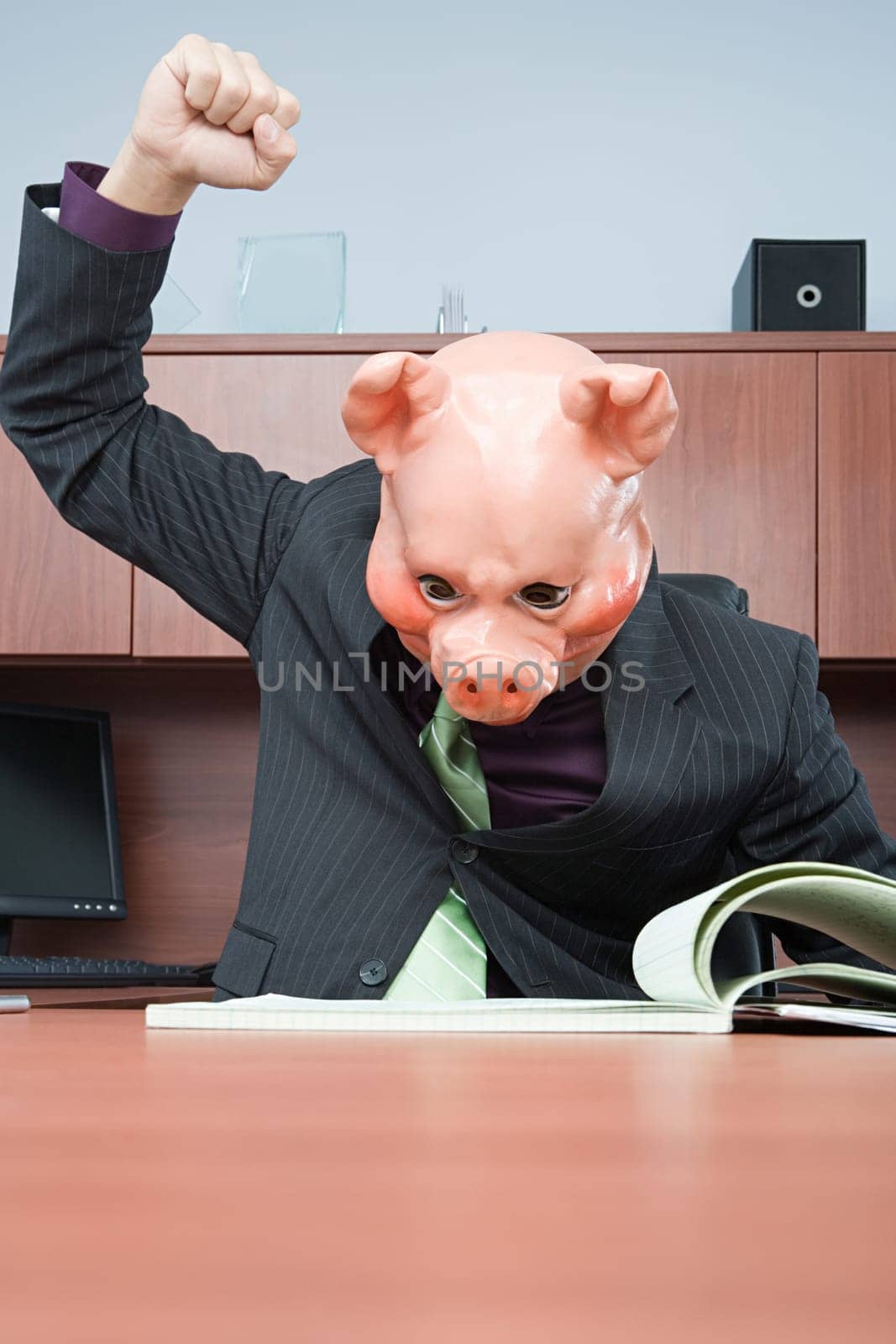 Businessman in pig mask reading