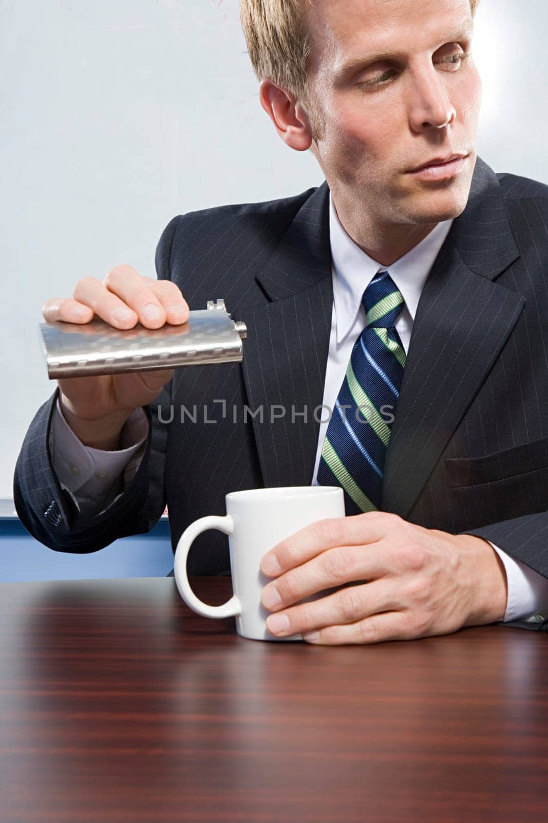 Businessman holding hip flask