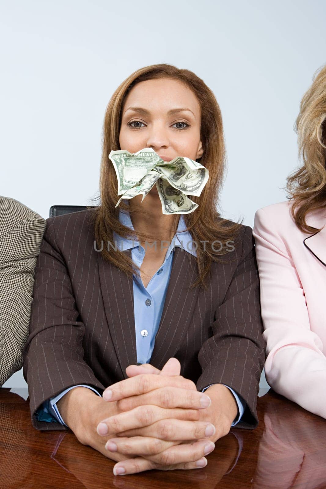 Businesswoman with money in her mouth