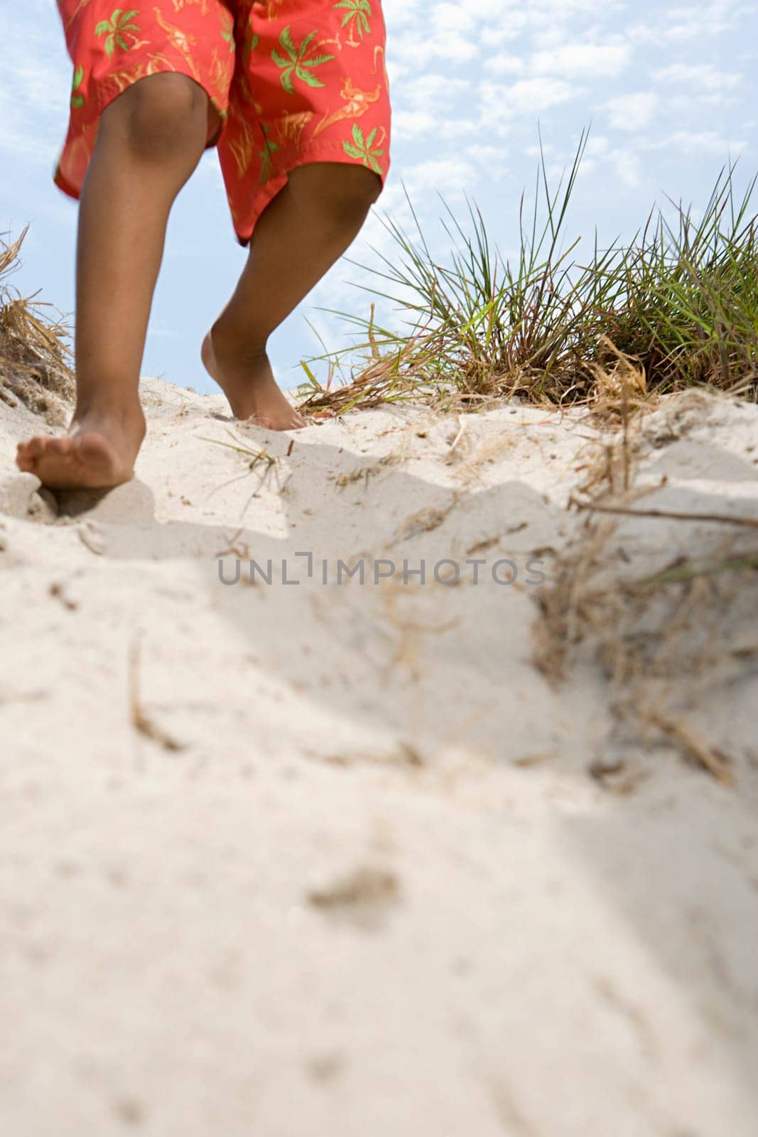 Child walking down dune