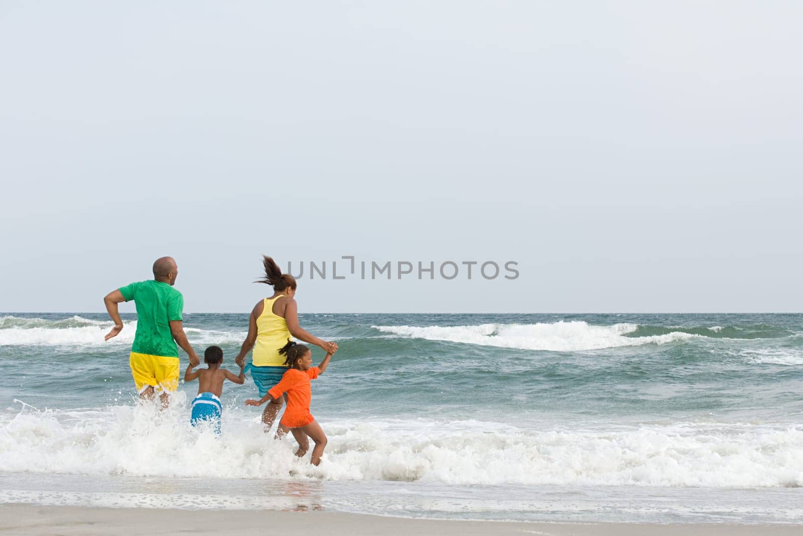 Family jumping in the sea