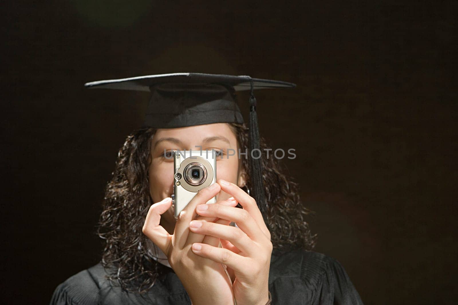 Female graduate taking a photograph