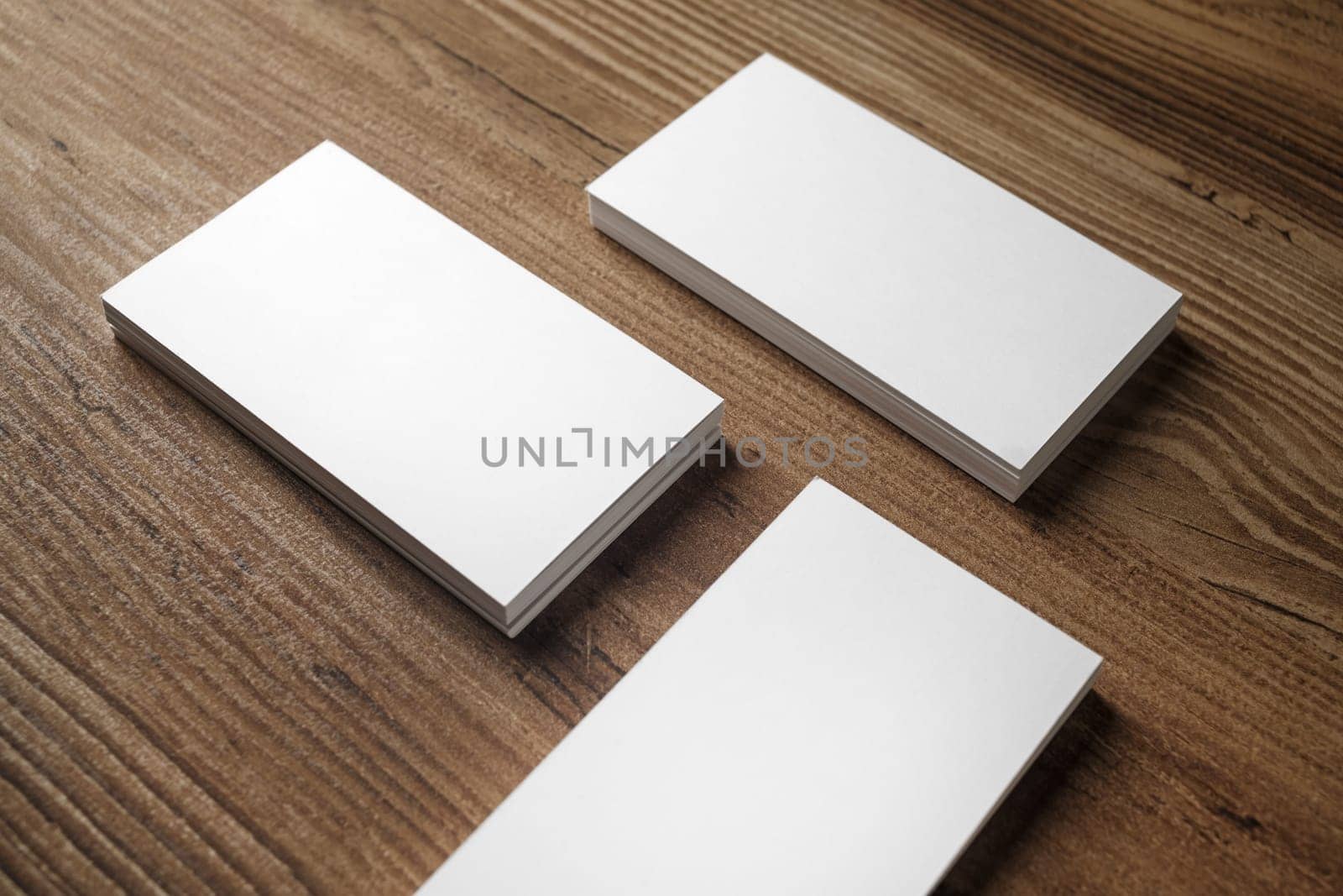 Photo of blank business cards on wooden background. For design presentations and portfolios.