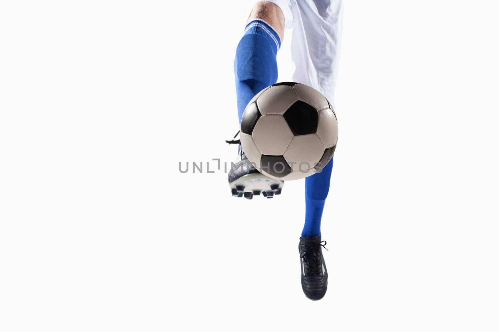 Athlete kicking soccer ball