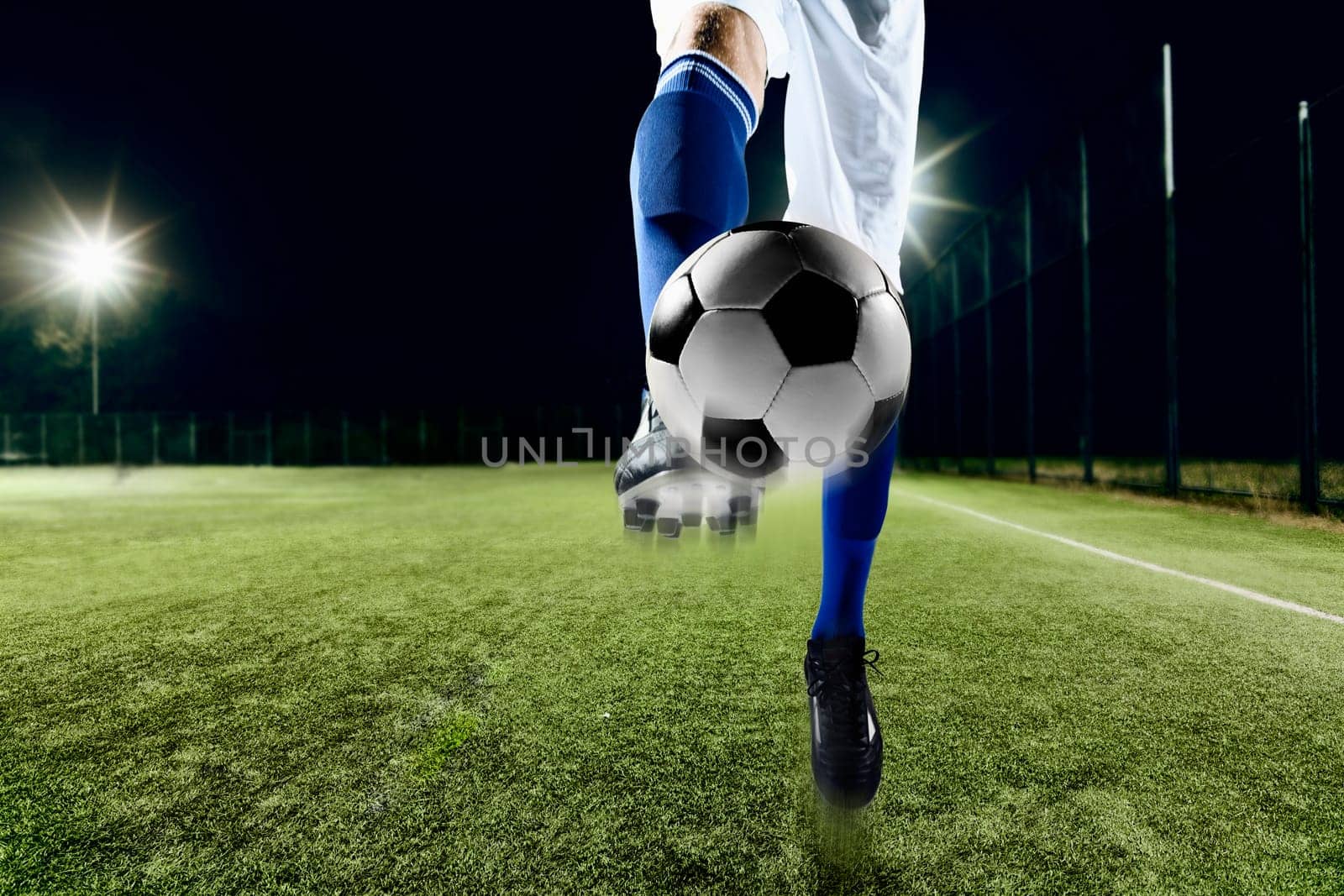 Athlete kicking soccer ball