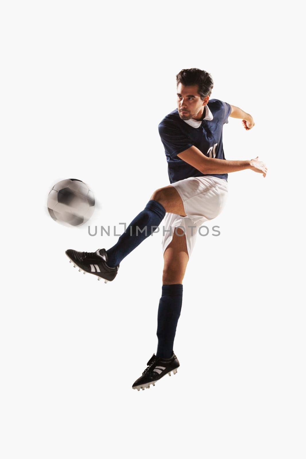 Soccer player kicking soccer ball