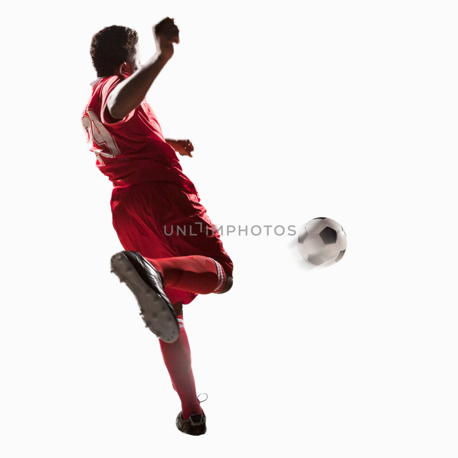 Soccer player kicking soccer ball
