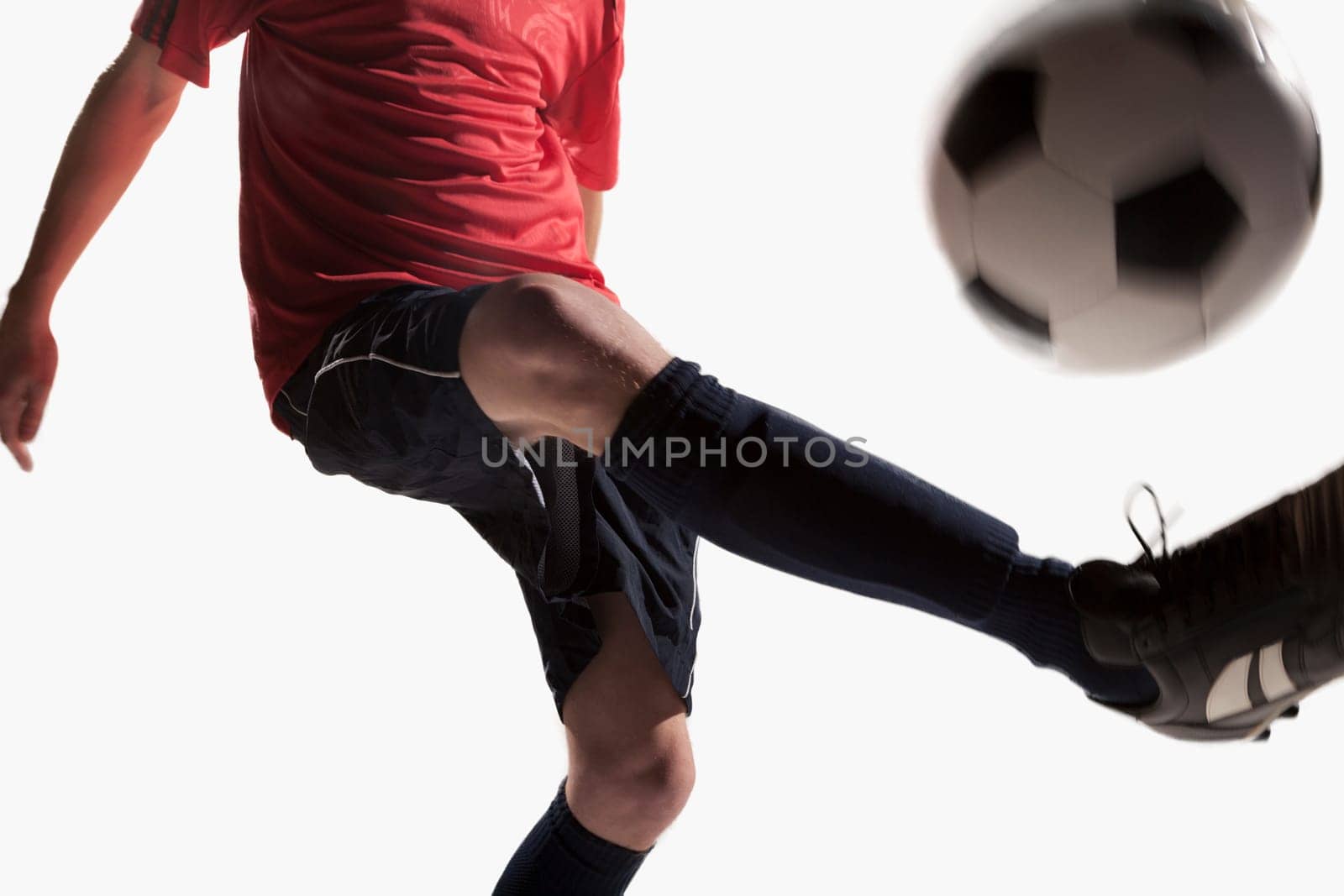 Soccer player kicking soccer ball
