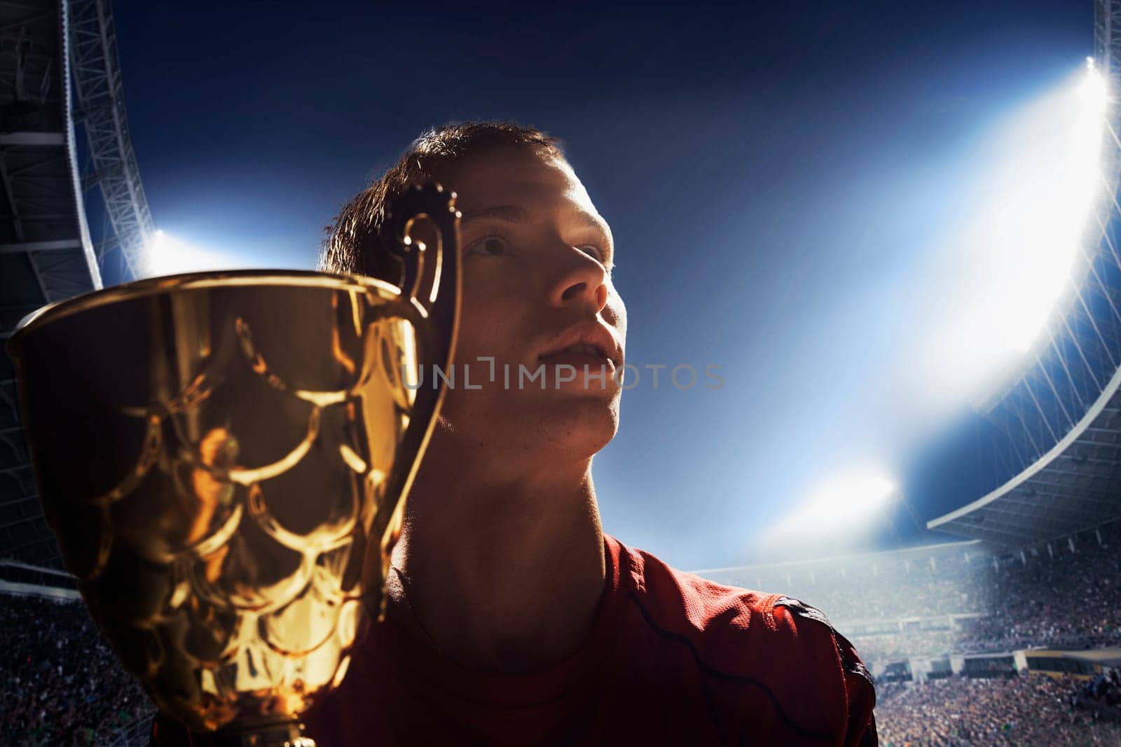 Athlete cheering with trophy cup