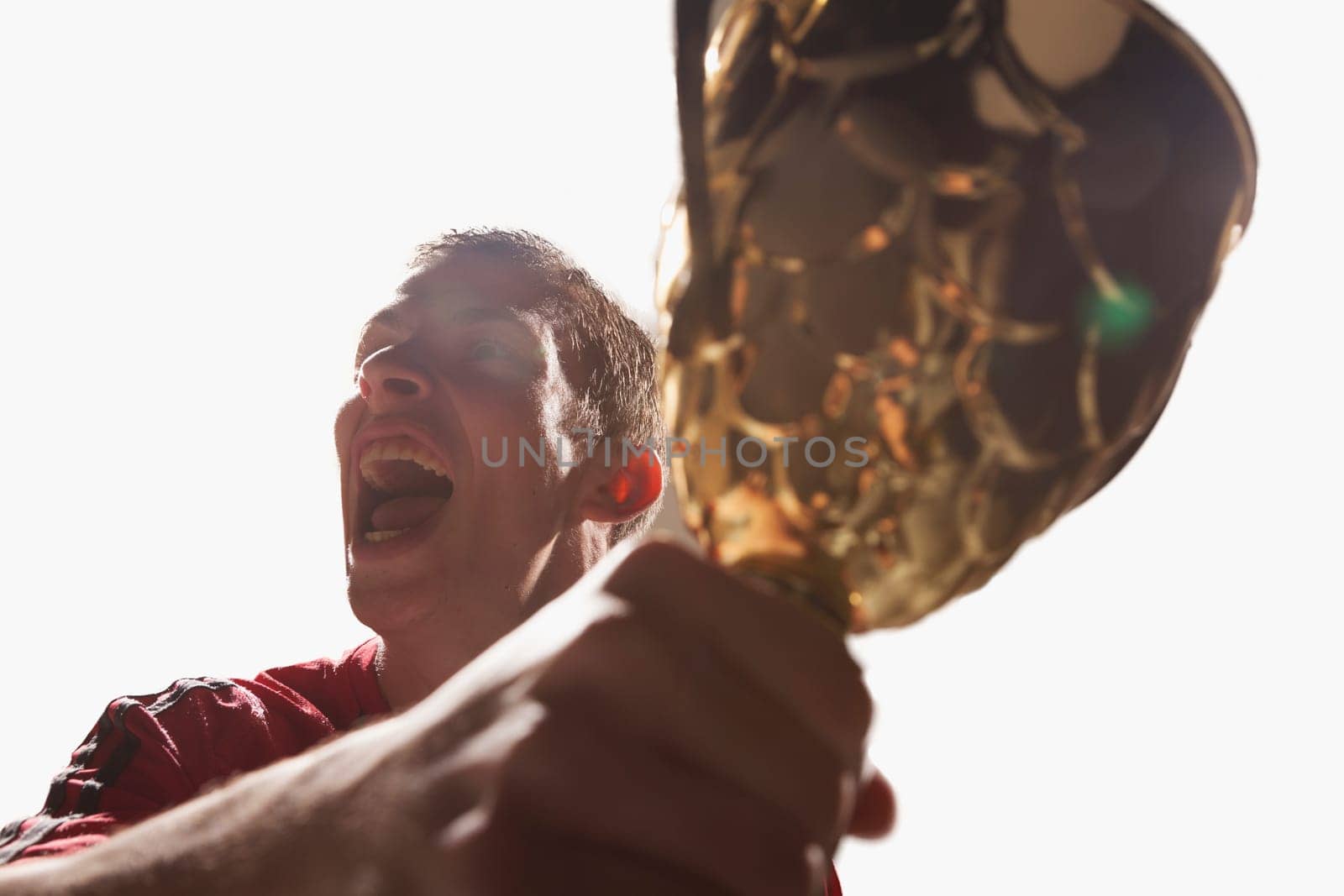 Athlete cheering with trophy cup