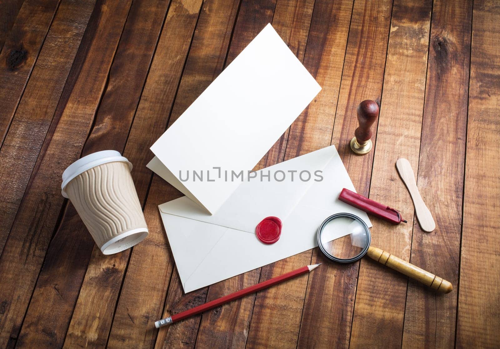 Blank stationery template on vintage wood table background. Vintage still life with postal accessories. Top view.