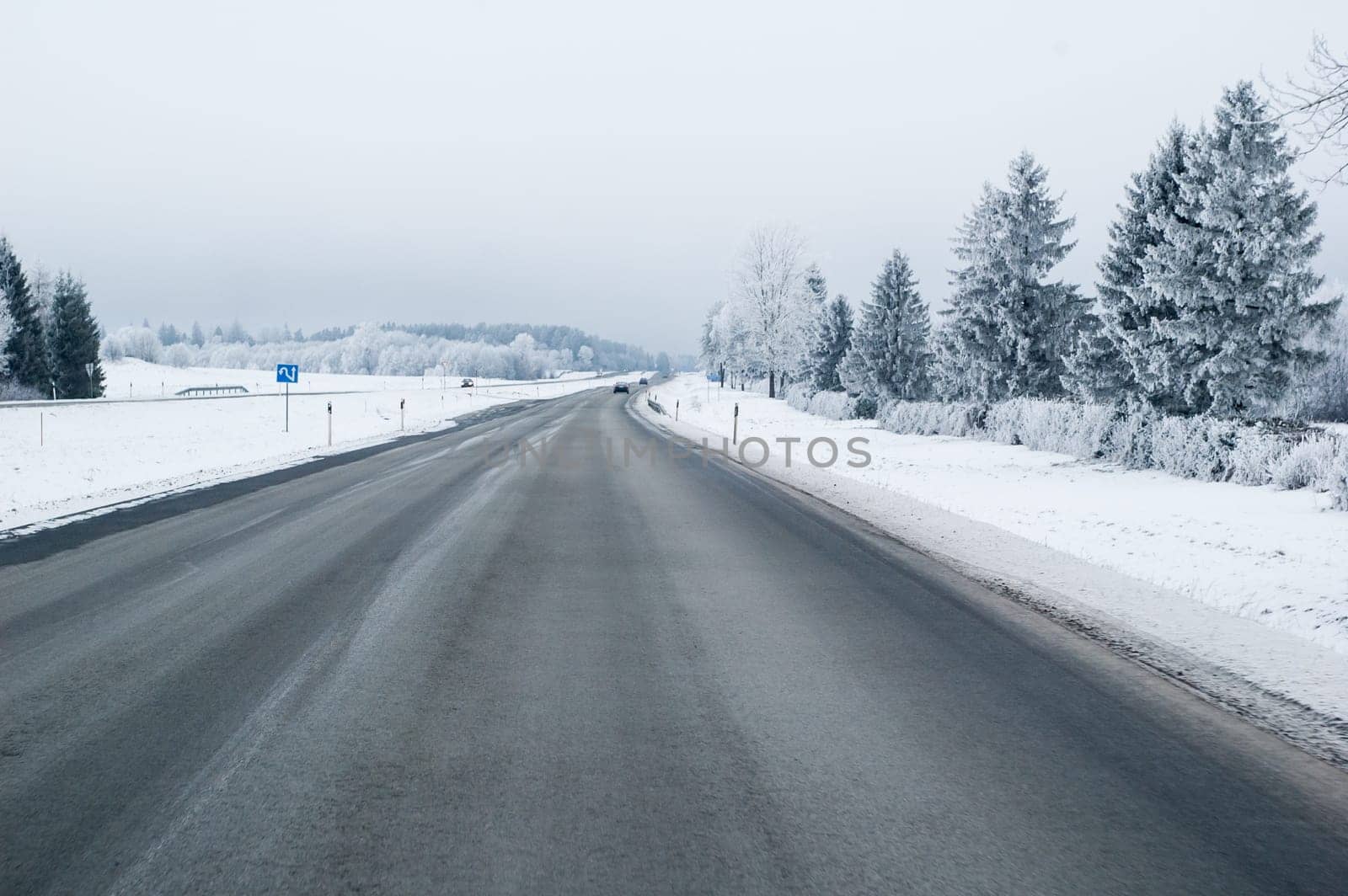 Highway in the winter, the trees covered with hoarfrost