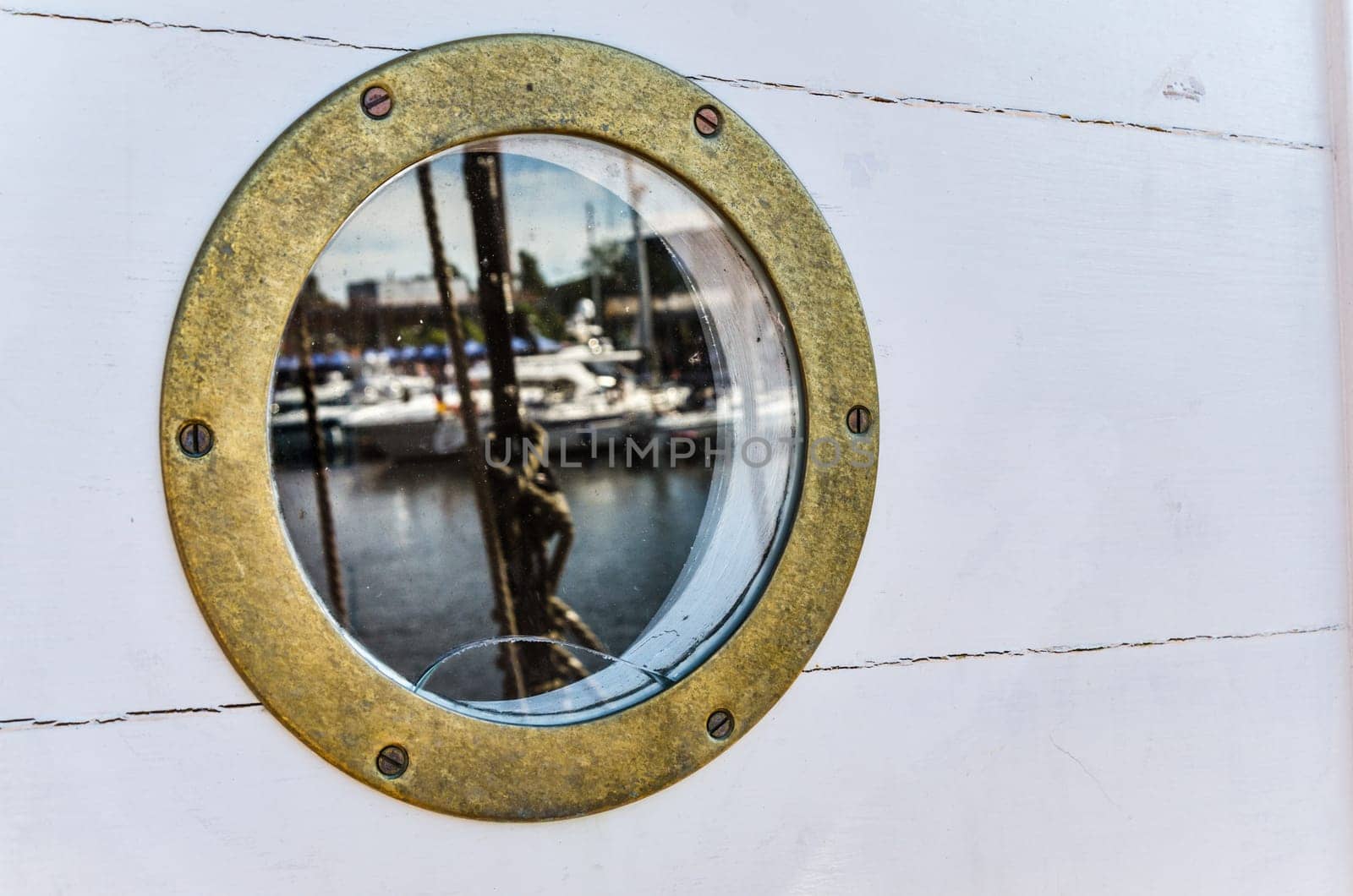 wood background and nautical porthole, close-up