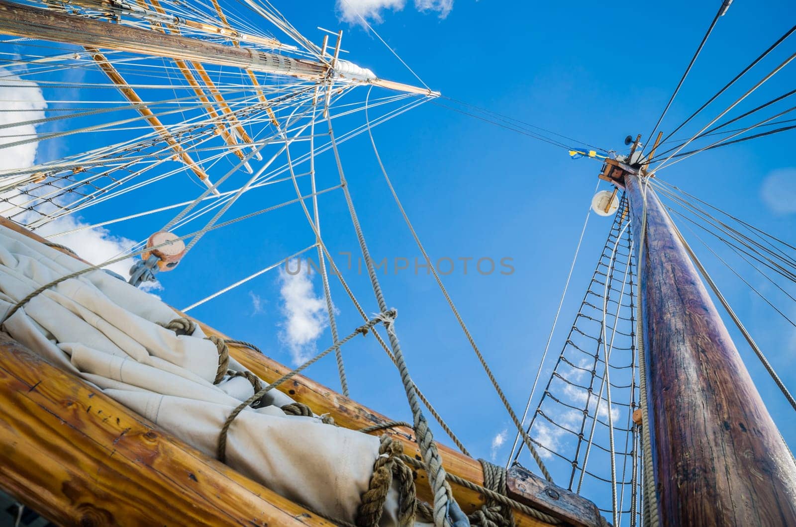 Folded sail and mast on an old sailboat
