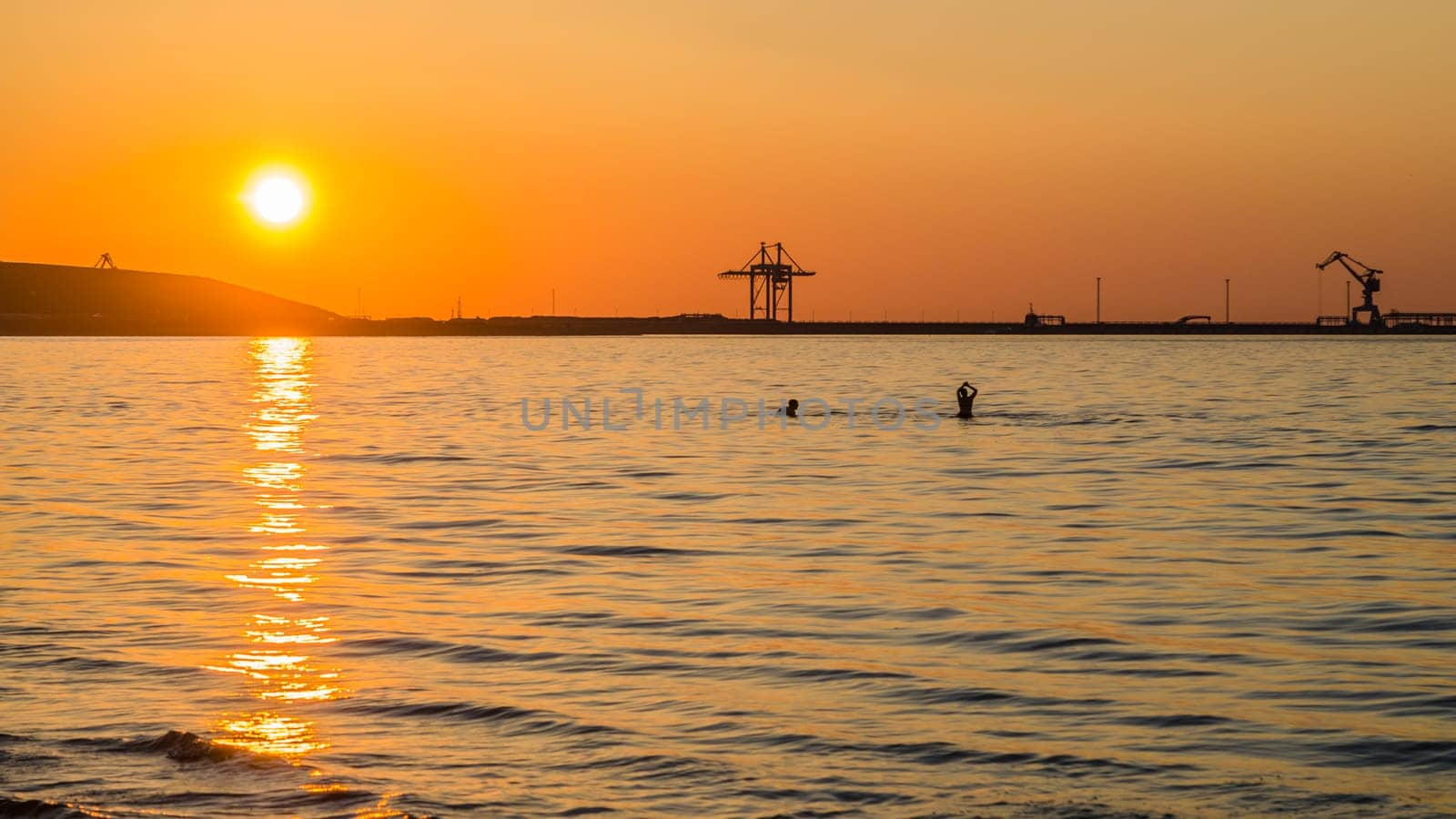 Couple bathing at sunset in the sea