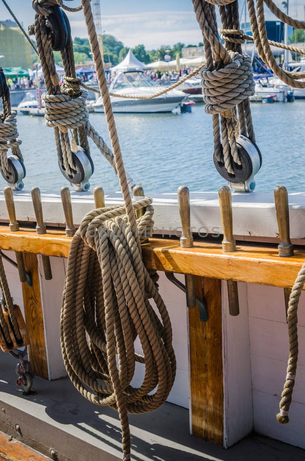 Rigging on the old sailboat against the background of modern yachts