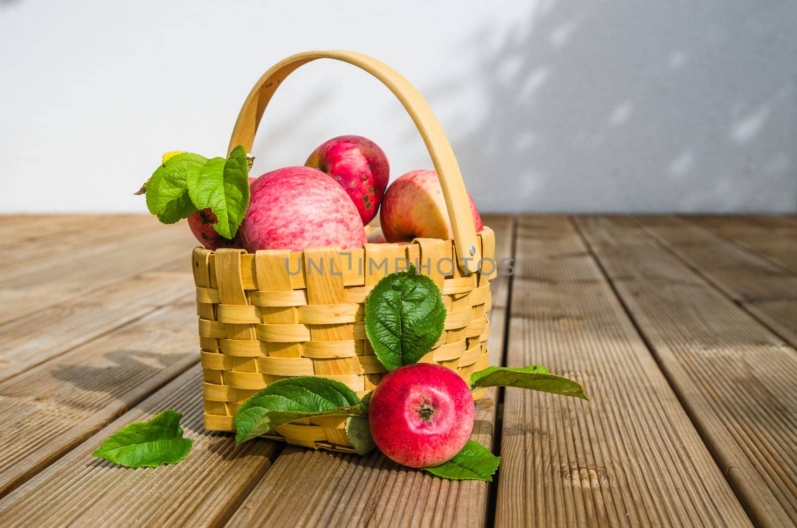 Basket with ripe red apples, close-up