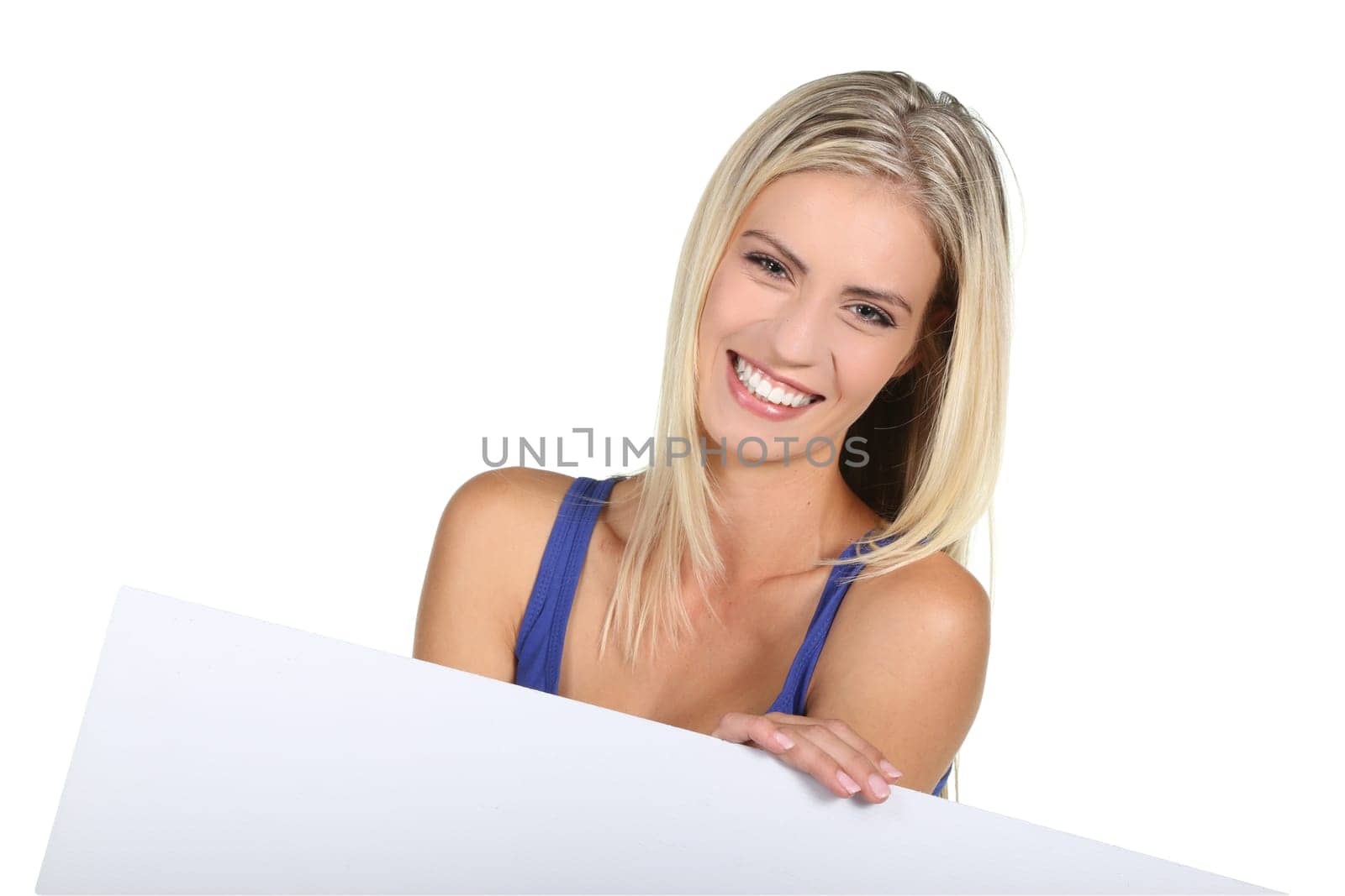 Beautiful young lady pointing to a sign board which she is holding