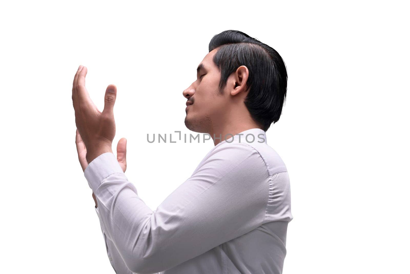 Young asian muslim man raising hand and praying isolated over white background