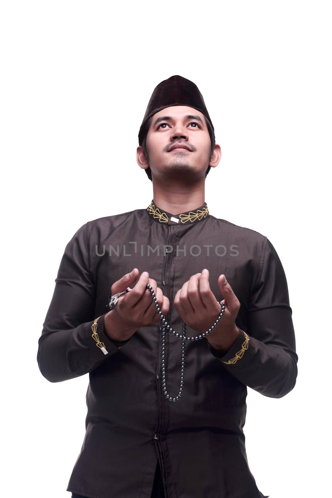 Young asian muslim man praying with prayer beads isolated over white background