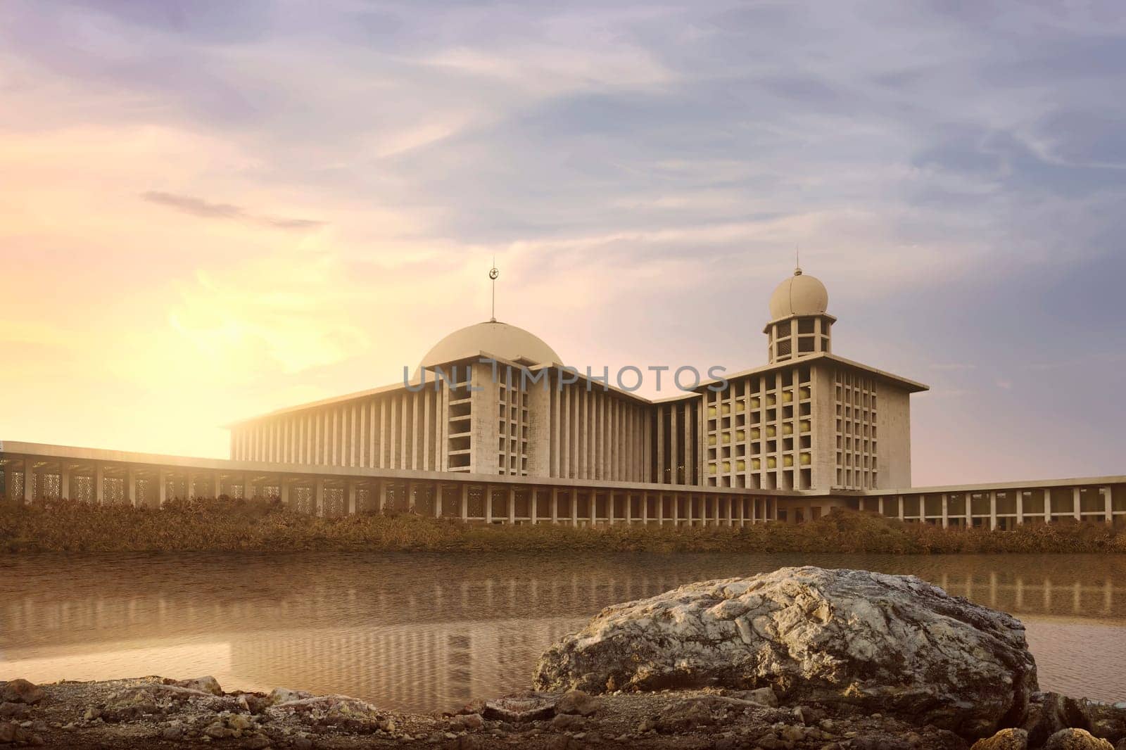 Lake with reflection beautiful and majestic mosque in sunrise light