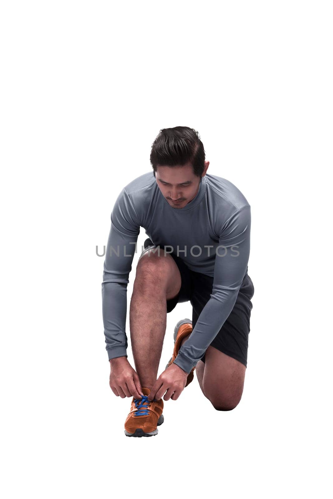 Sporty asian man sit down tying shoelaces ready for running isolated over white background