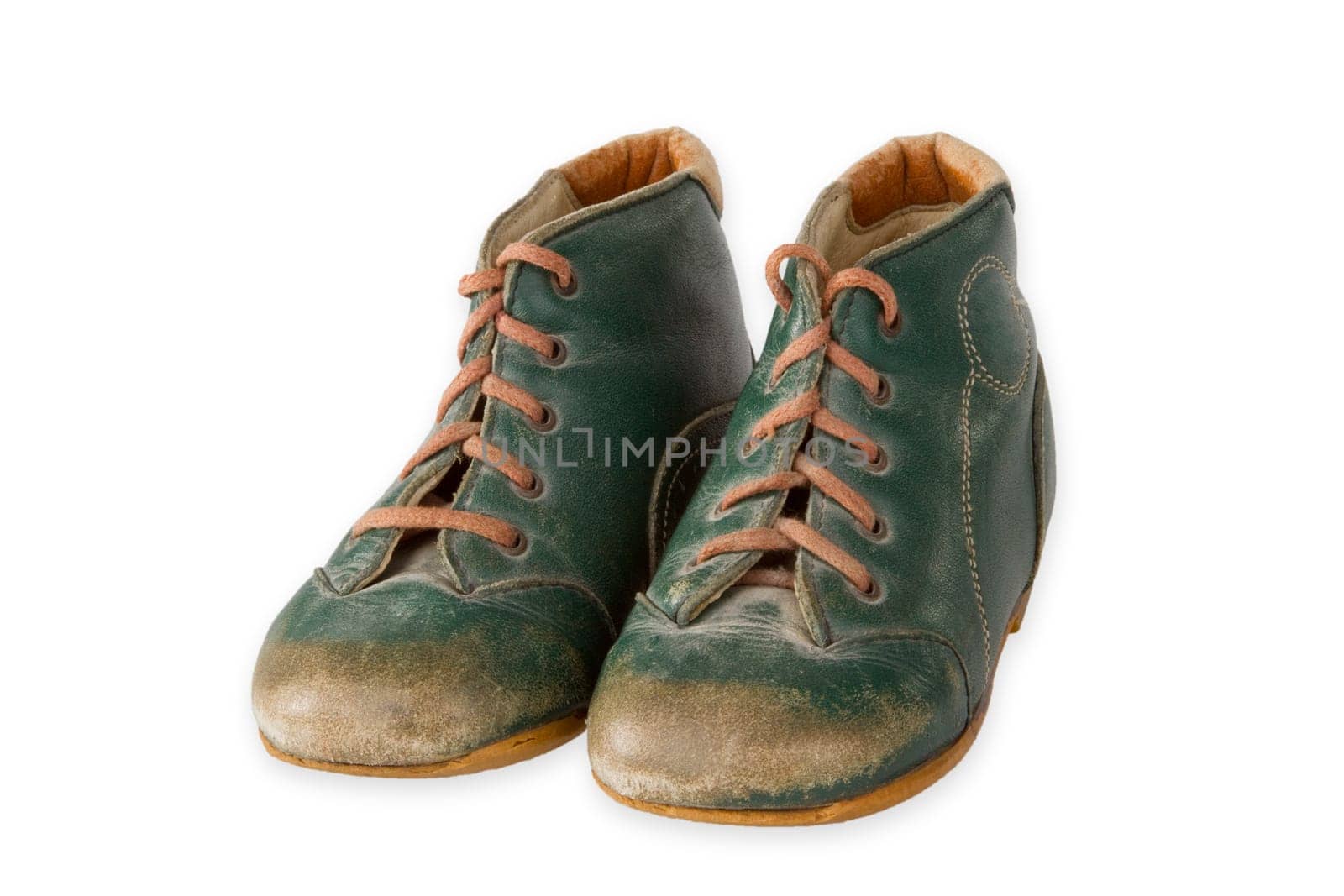 Old baby shoes exposed on a light background
