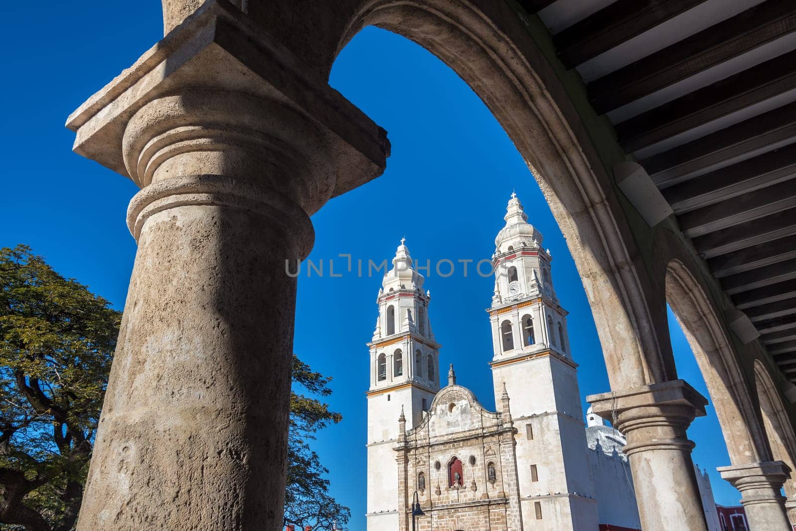 Cathedral in Campeche, Mexico seen through a stone arch