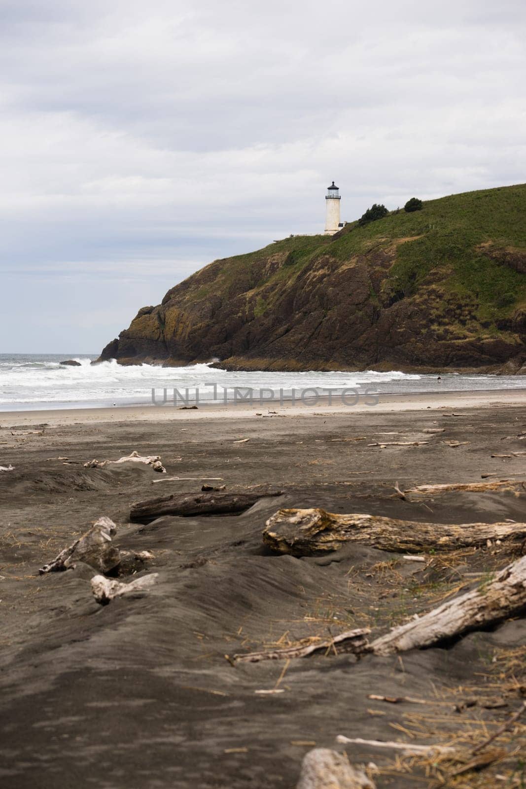 Vertical composition of beach below bluff that holds the North Head Lighthouse