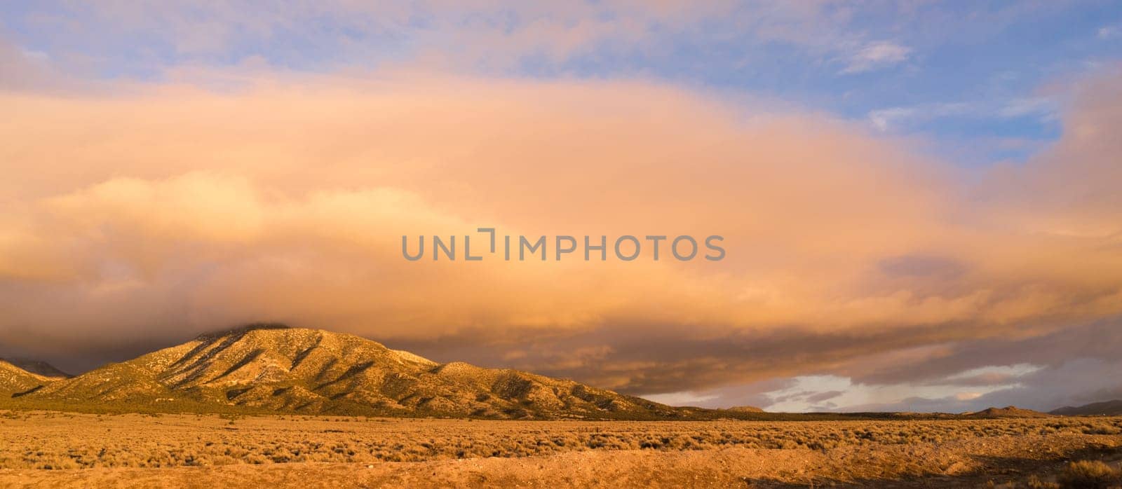 Panoramic Landscape Clouds Over Hillside Sunset Orange Glow