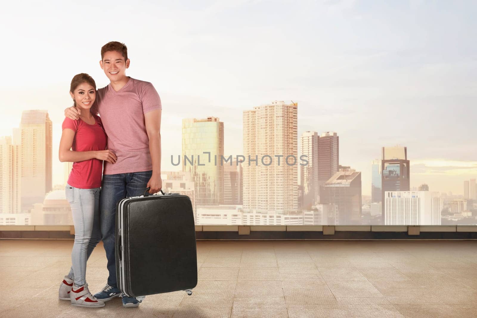 Happy asian couple tourists with suitcase in the city background