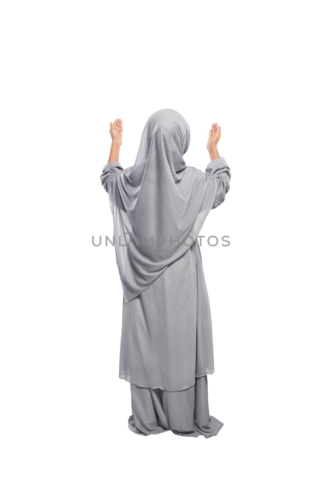 Back view asian muslim girl raising hand and praying isolated over white background