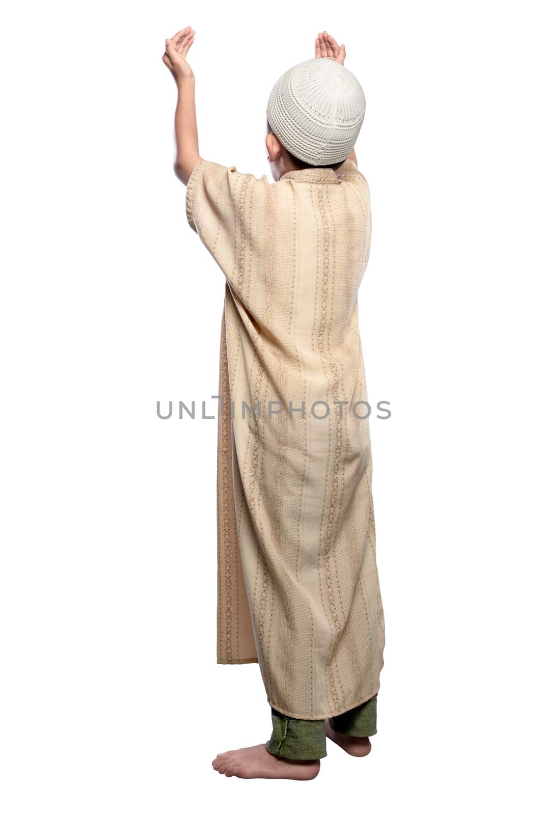 Back view of asian muslim kid raising hand and praying isolated over white background