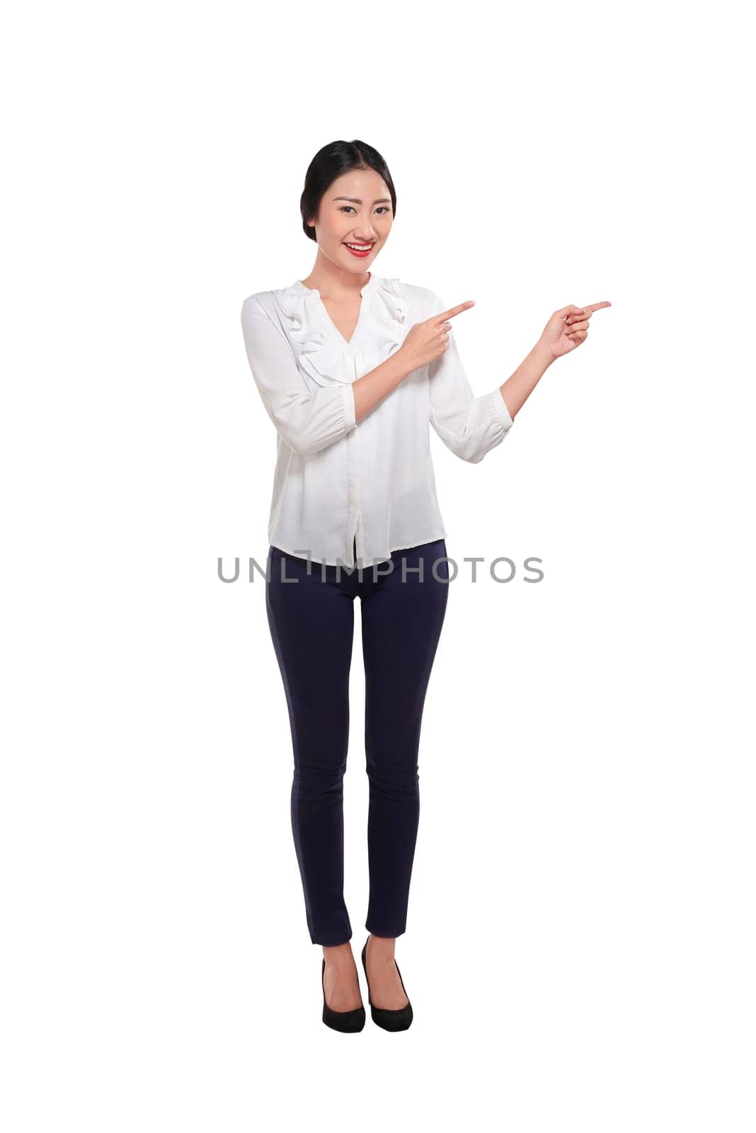 Pretty asian businesswoman pointing something with her two hands isolated over white background