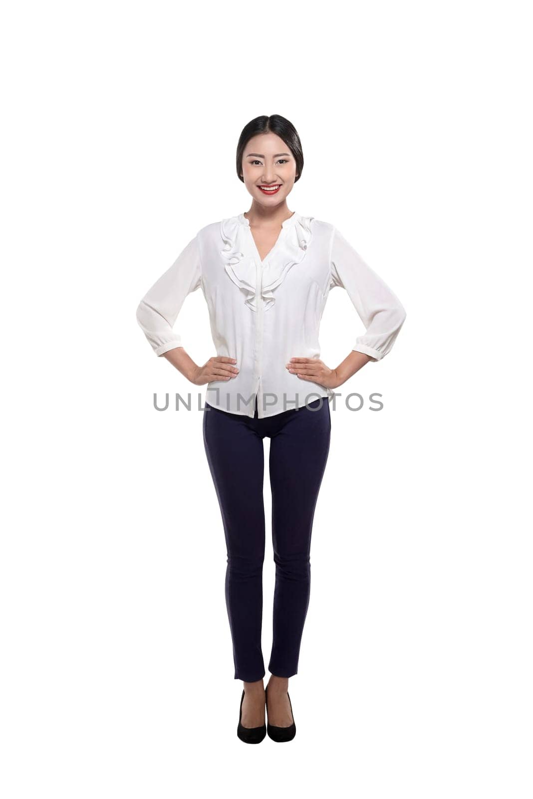 Beautiful asian business woman posing with hands on waist isolated over white background