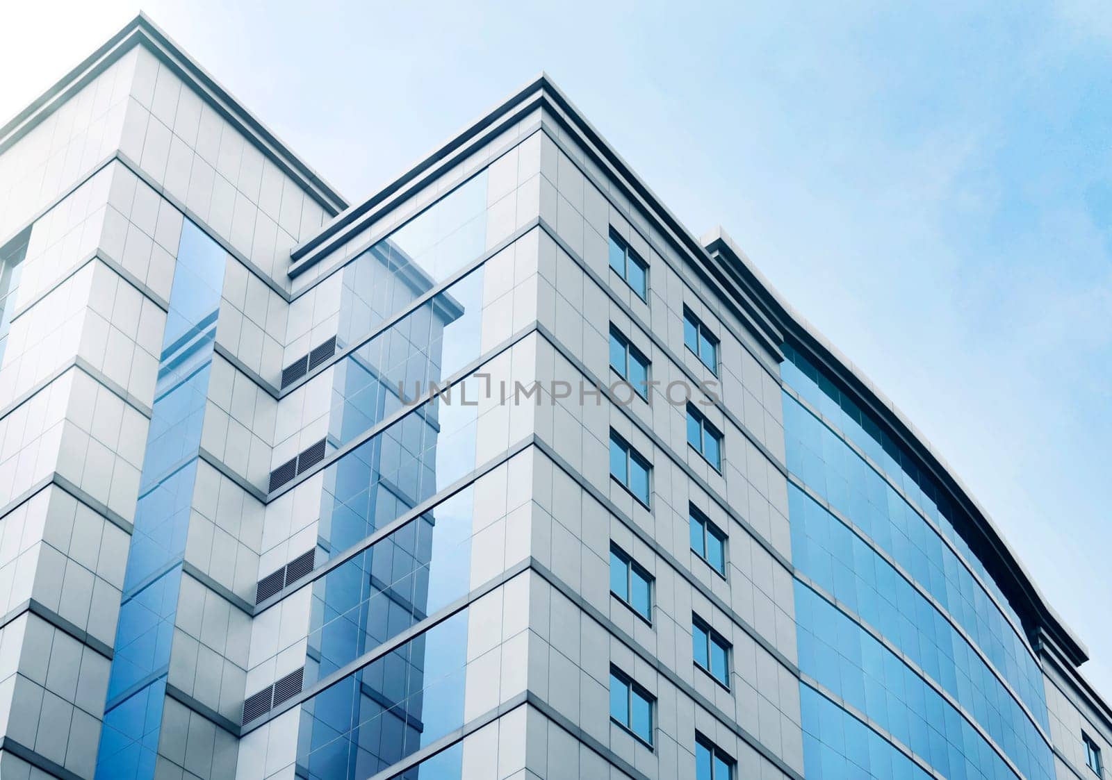 Windows of business office building with blue sky in the city