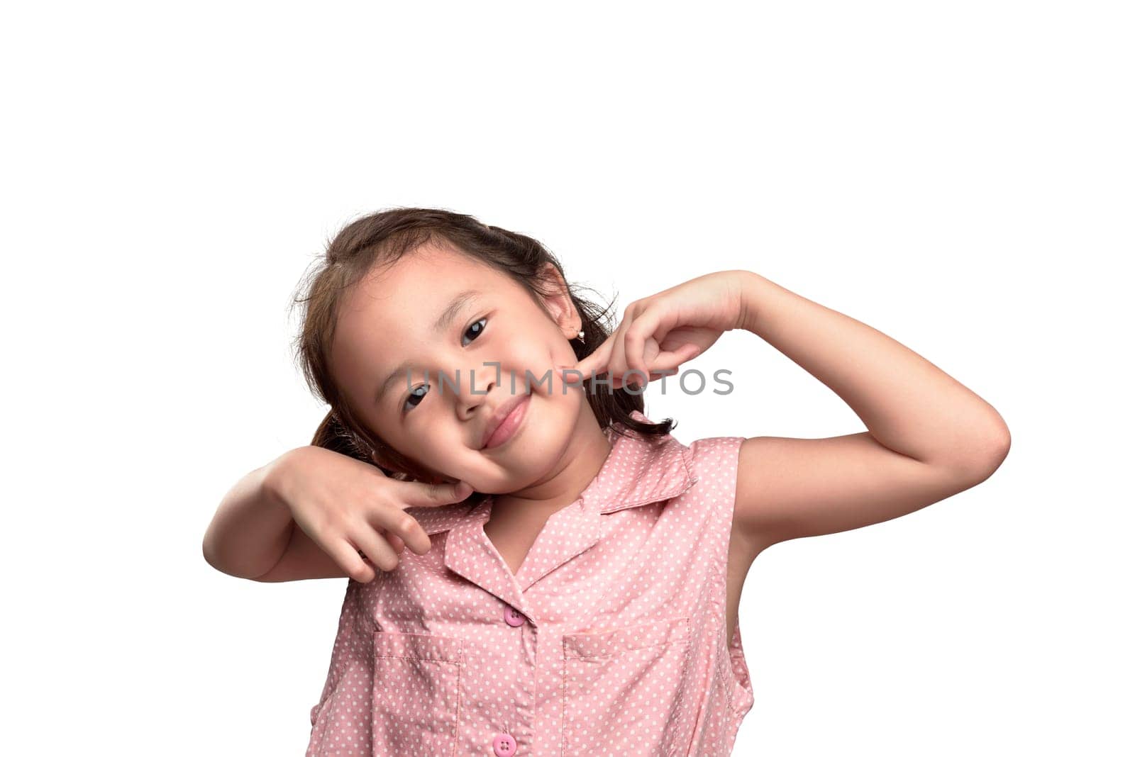 Cheerful asian little girl in pink dress with excited expression isolated over white background