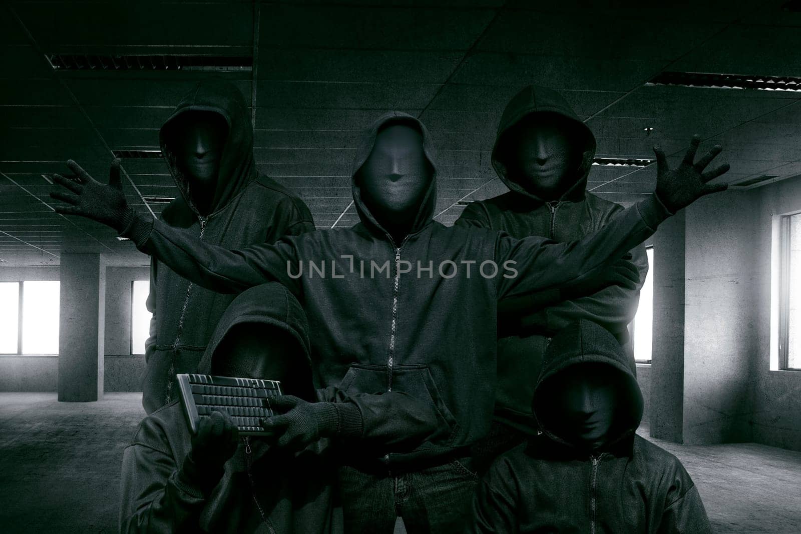 Group of hooded hacker with mask standing in the dark room background
