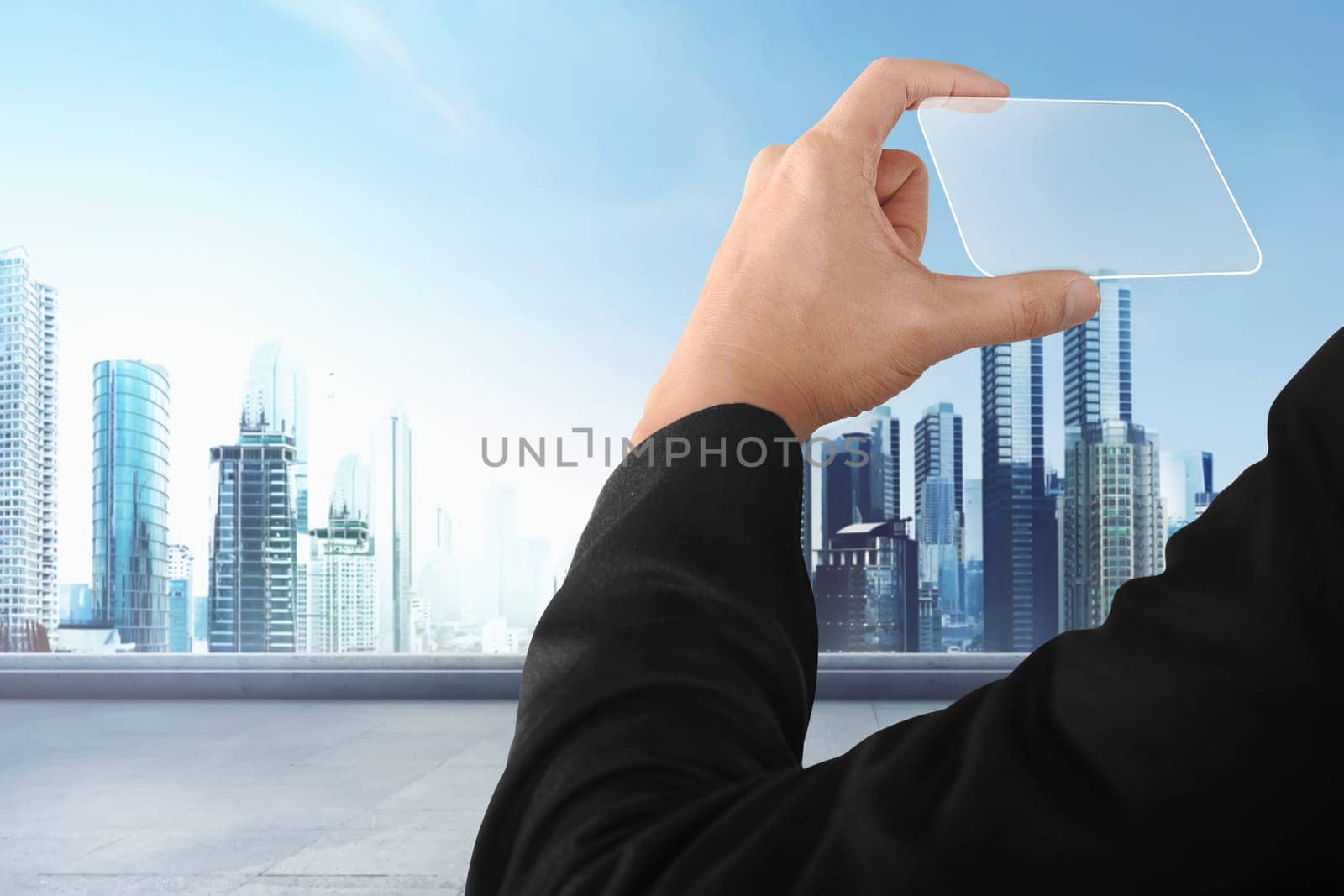 Business hand holding futuristic business card with modern city background