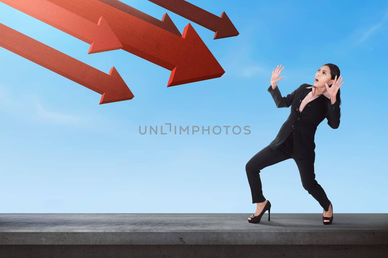 Shocked asian business woman with red arrow going down to her on the sky background