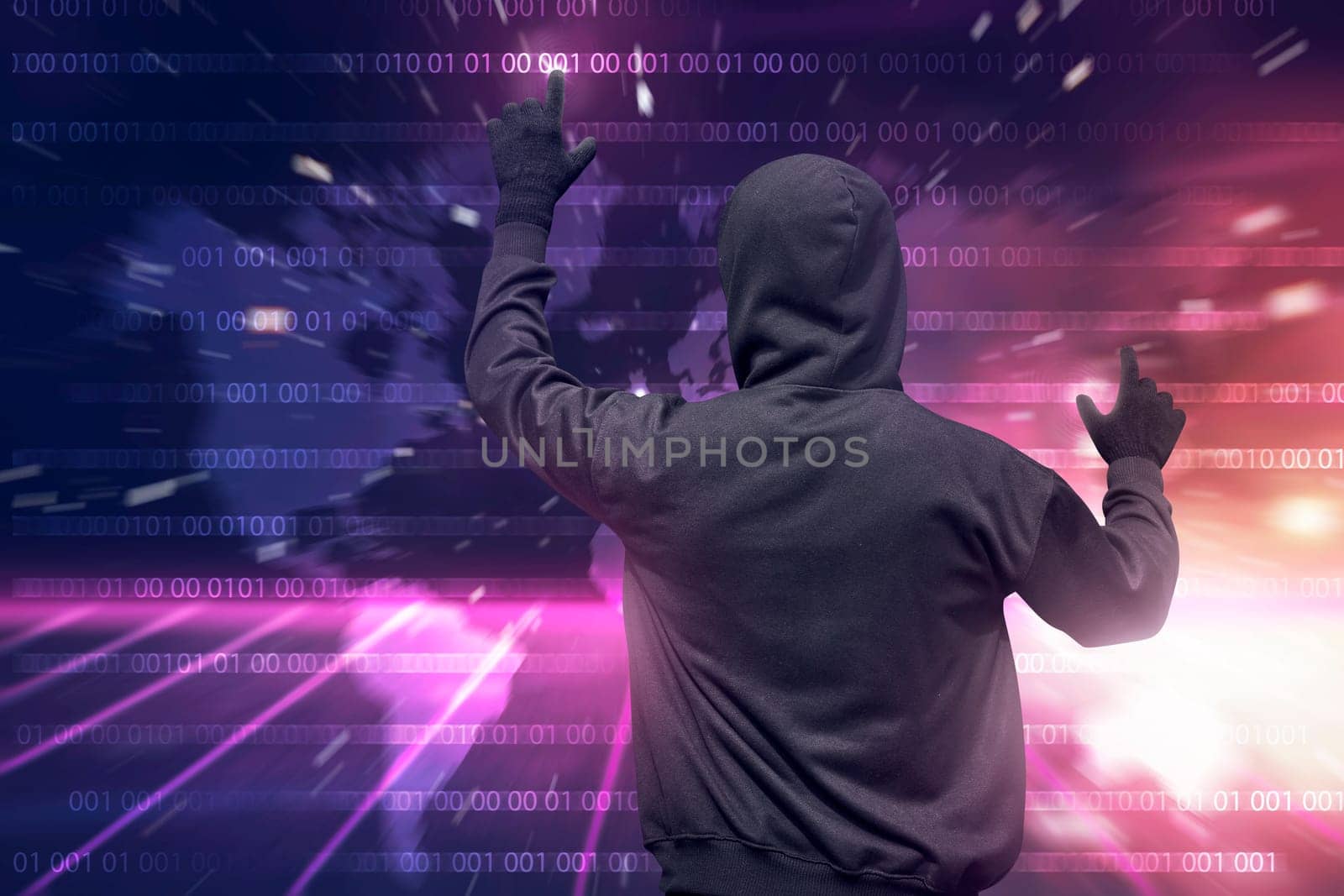Rear view of hooded hacker using virtual screen to hacking internet system security