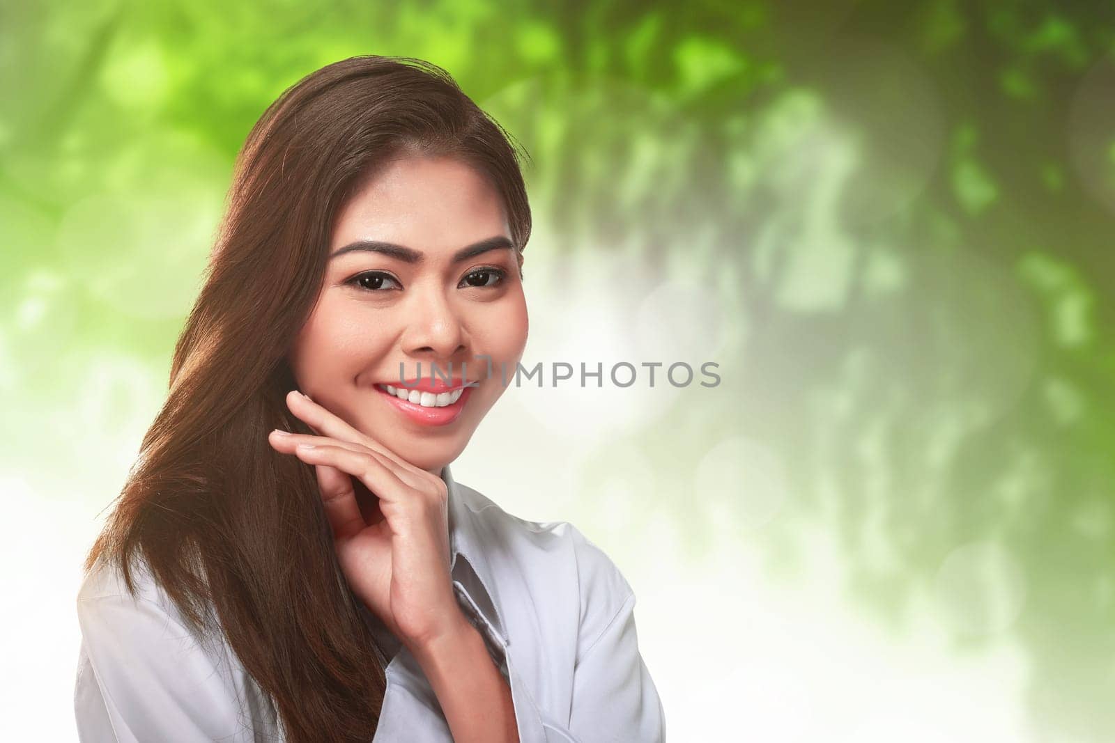 Close up of young asian woman with perfect makeup on green background