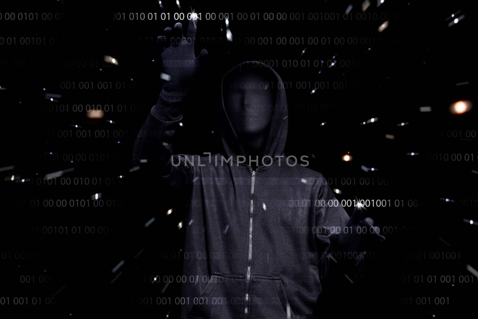 Hooded man with anonymous mask hacking binary system security code on the virtual screen