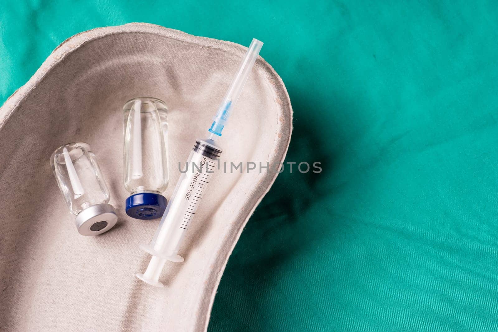 Medical Stethoscope lying on the hospital's green background. The background can be a textile part of a doctor or nurse's work uniform