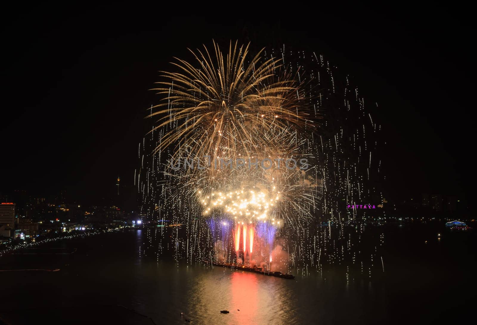 Big firework on the sky at Pattaya coast with cityscape background, Thailand