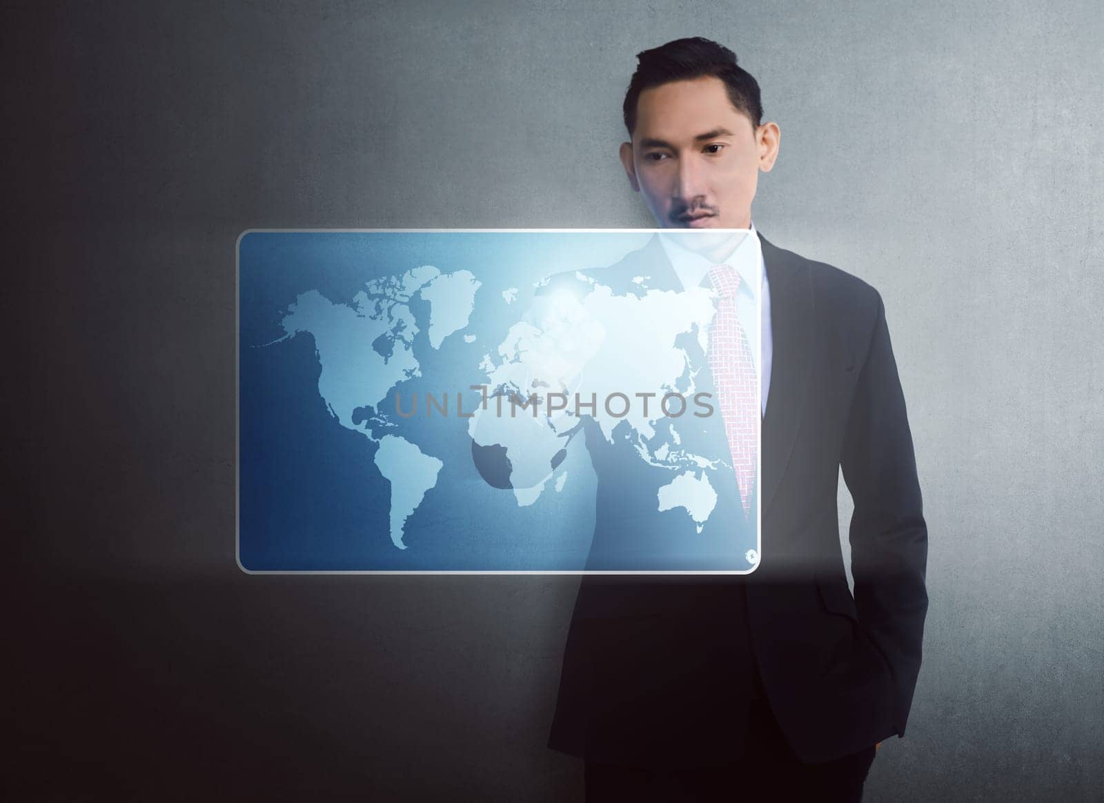 Modern asian businessman touching virtual world map on digital screen over wall background