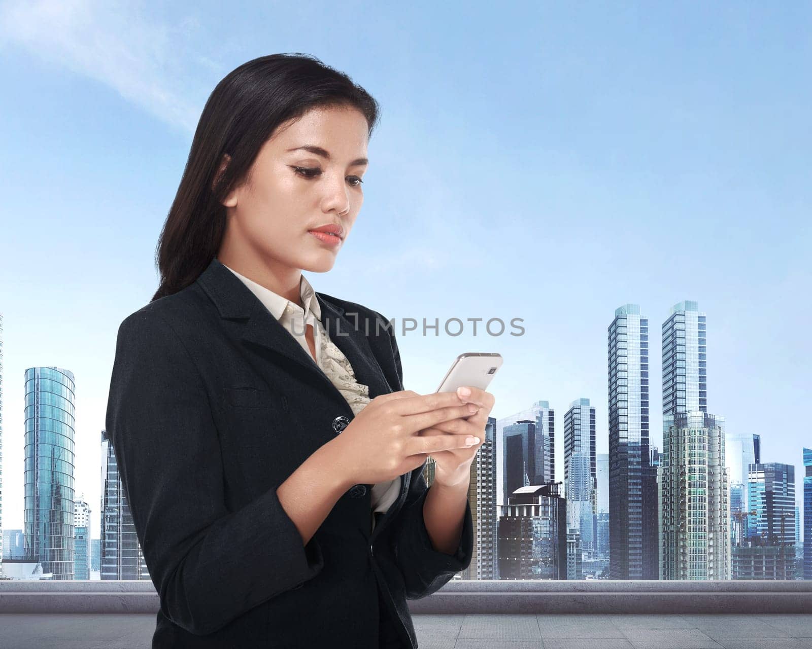 Beautiful asian business woman holding smartphone with cityscape background.